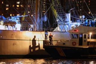 A New York Police Department harbor unit prepares to board the Cuauhtémoc, a masted Mexican Navy training ship that collided with the Brooklyn Bridge